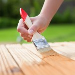 Applying protective varnish on a wooden furniture