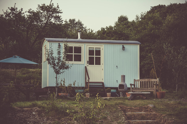 Small hut located in woodland clearing Woodland hideaway hut