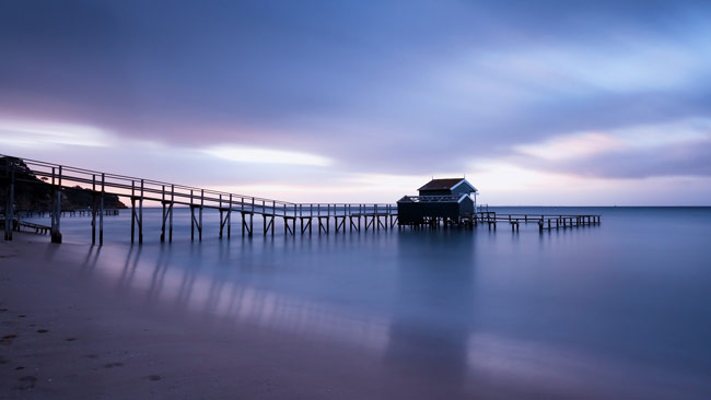 Seaside Jetty at Dawn with Blue Sea and Sky