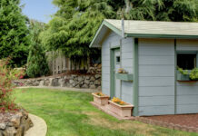Should I Preserve, Oil or Paint my Shed? A painted shed in a green garden