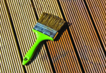 Top Treatment for Balau Decking Paint brush on top of decking