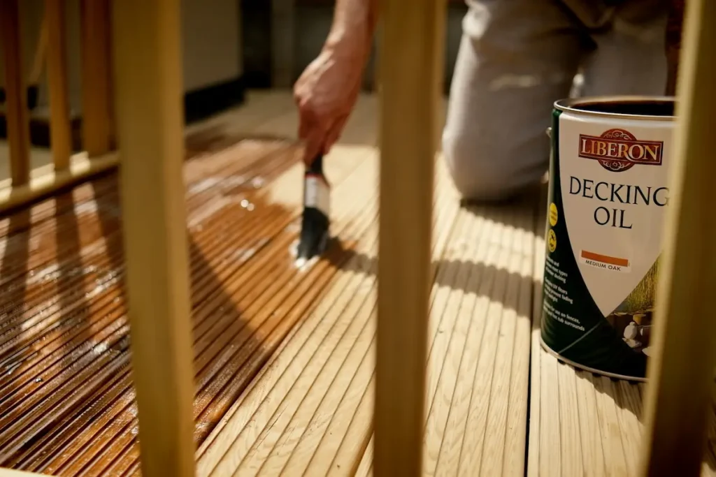 Applying Liberon Superior Decking Oil Medium Oak to wooden decking