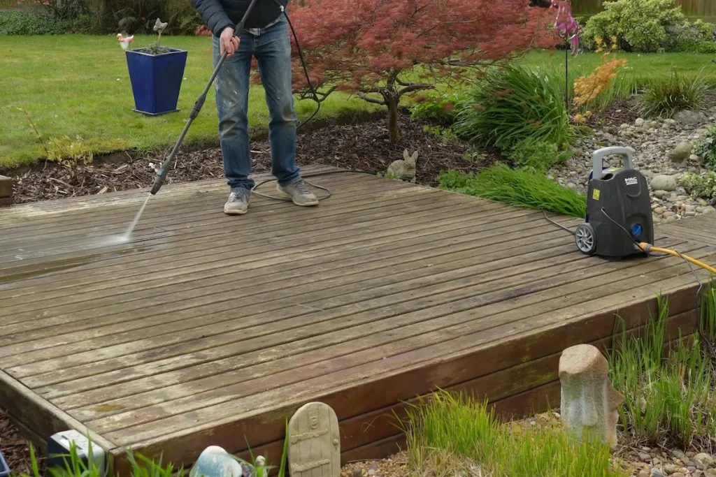 Cleaning old wooden decking with a pressure washer