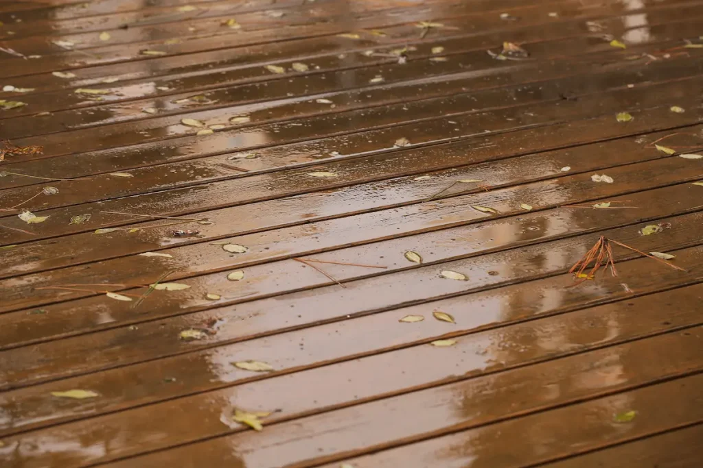 wet decking in the rain with leaves and debris