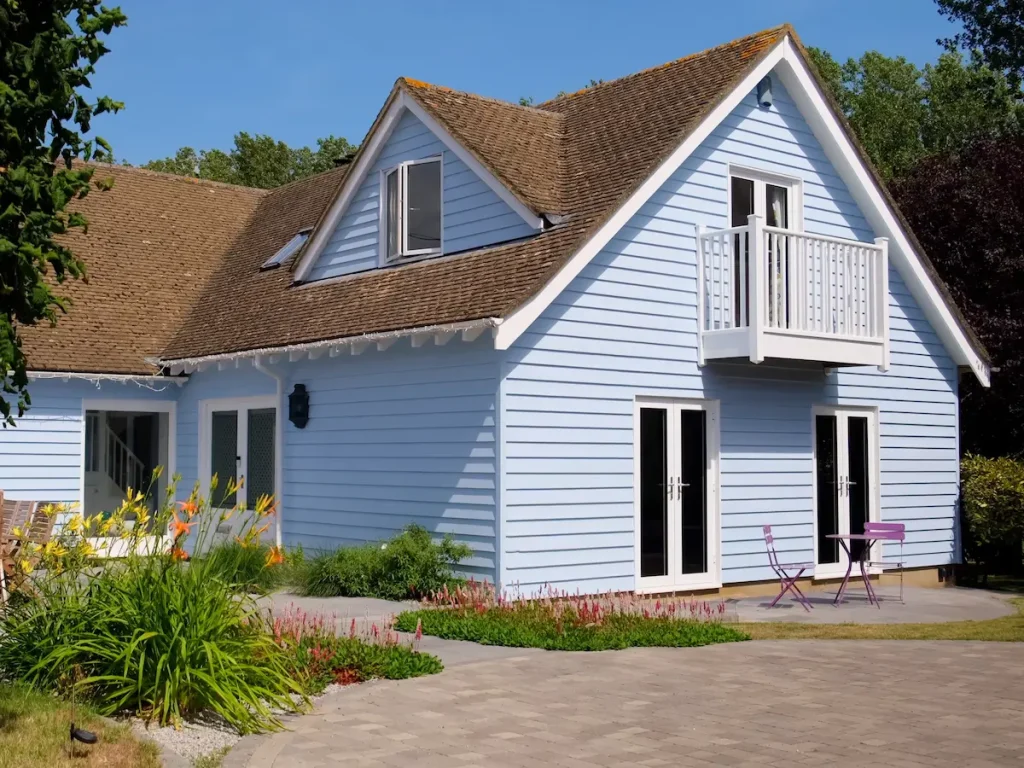 Colourful weatherboarded house using Sadolin Superdec